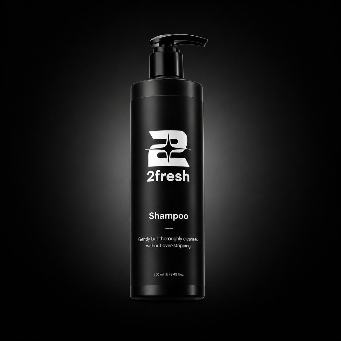 A tall black pump bottle of 2fresh Shampoo centered on a dark gradient background with a spotlight effect.