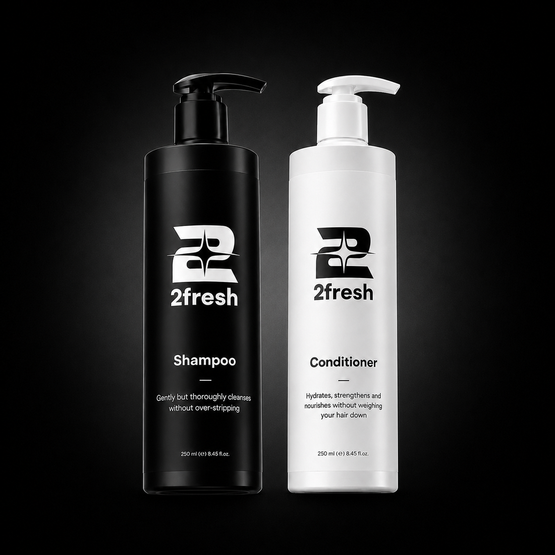 Two 2fresh haircare bottles on a black background: a black pump bottle labeled Shampoo and a white pump bottle labeled Conditioner.
