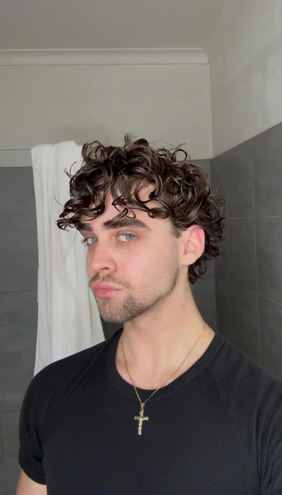 Man with defined curly hair after styling