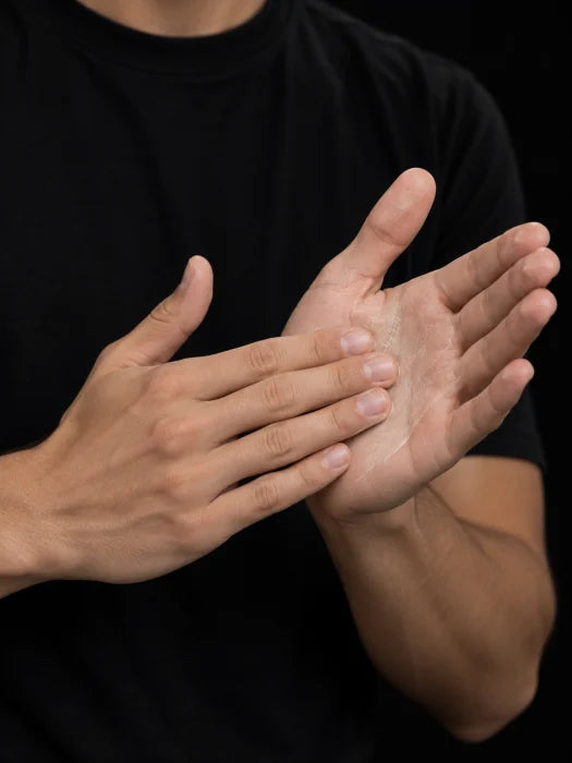 Spreading Hair Clay into a thin layer between palms and fingertips